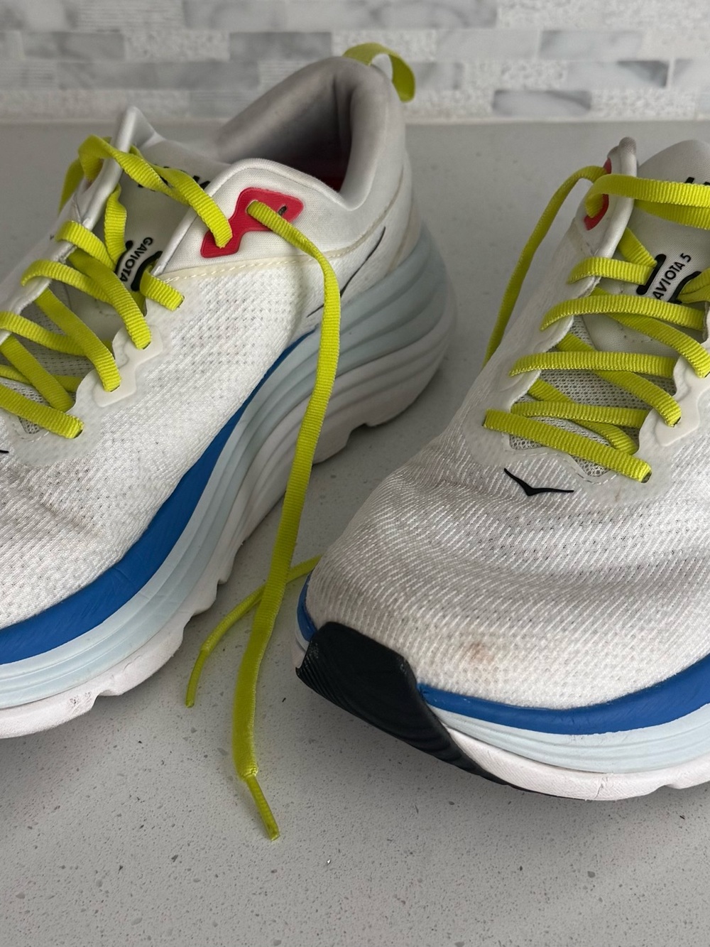 Hoka White Running Shoes with Neon Yellow Laces and Blue Accents